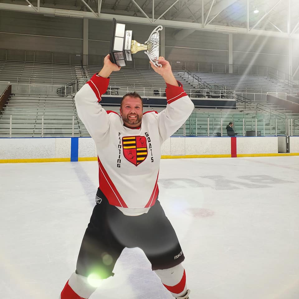 80094699_10156704895480318_8319841776839950336_n Dr. Steve Baker at a hockey game holding a trophy over his head